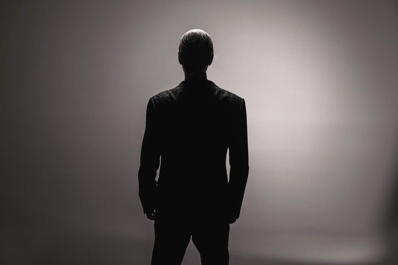A composed, disciplined figure standing with quiet self-possession